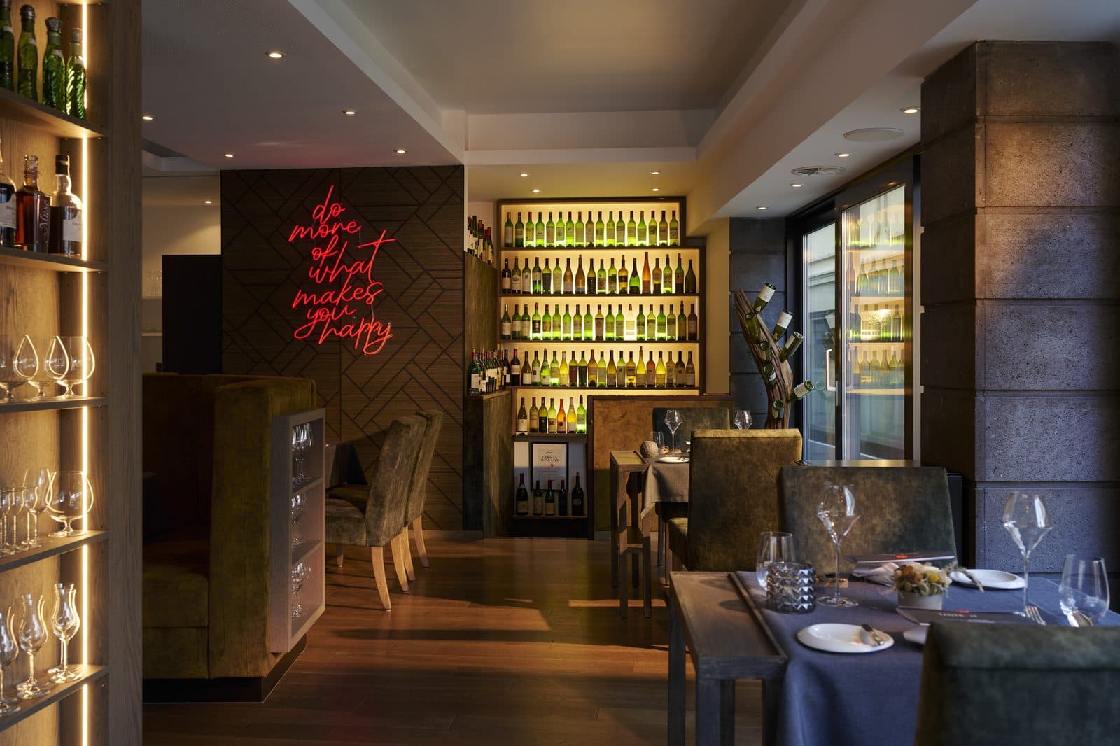 Gastraum der Christian & Friends Tastekitchen - Neon, Wein, gedeckte Tische